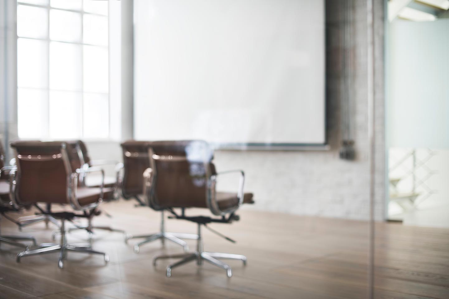 Chairs face a projection screen